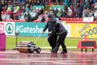 Clearing away the water while being filmed at the European Athletics Team Championships.